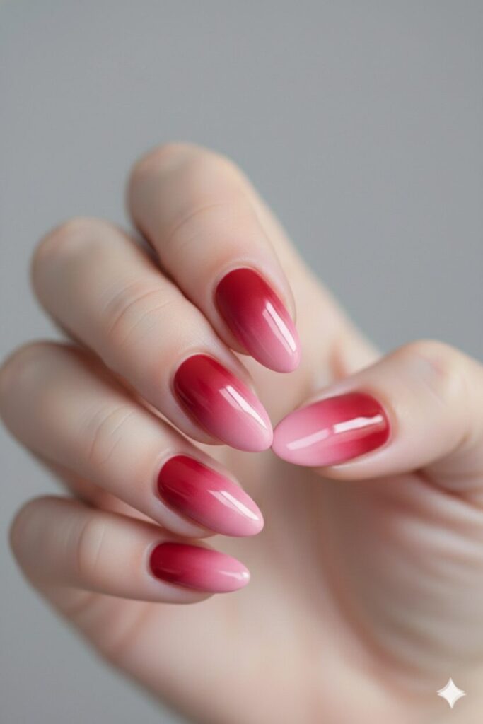 Dreamy valentines nails with a smooth ombre gradient fading from red to pink.