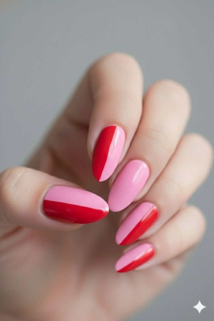Modern two-tone valentines nails with half red and half pink color block design.
