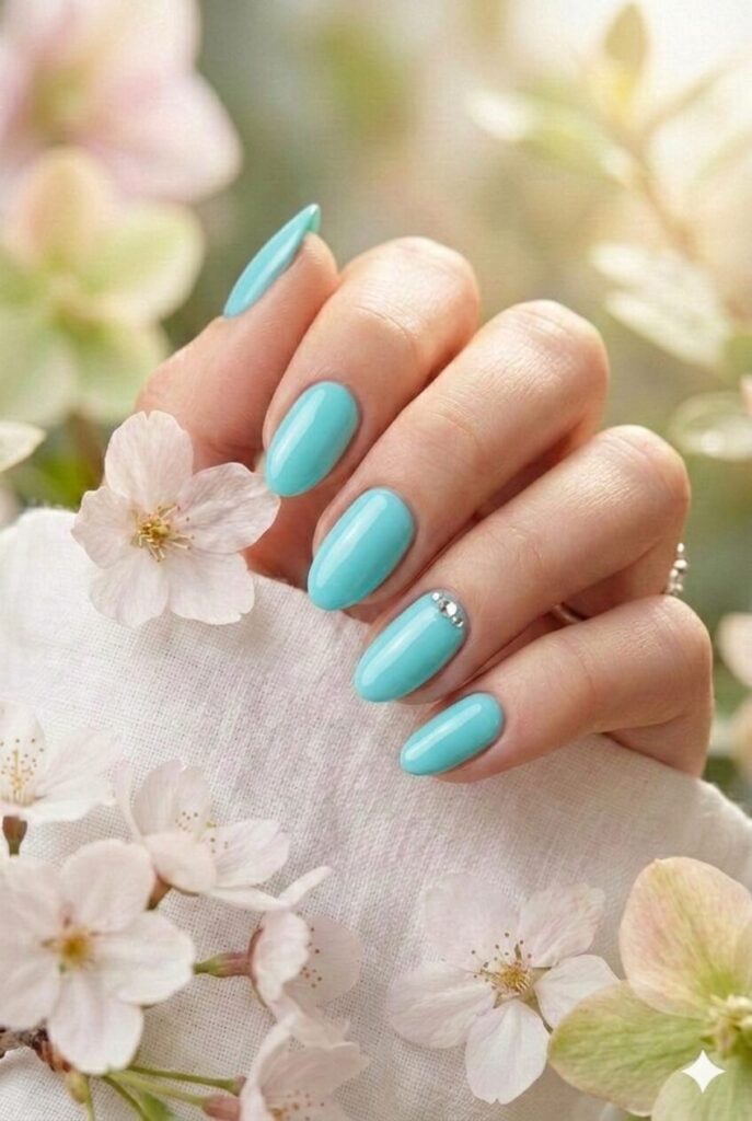 Aqua blue spring nails with bright fresh blue-green shade like swimming pools, refreshing tropical manicure for spring 2026
