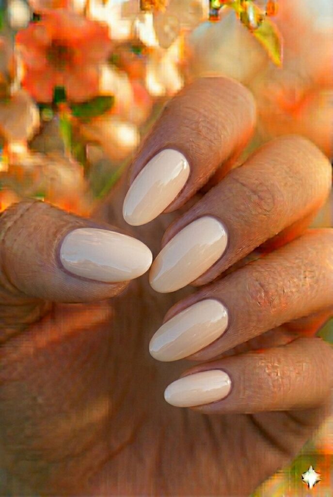 Oat milk spring nails with creamy warm white neutral shade on oval nails, natural sophisticated manicure for spring 2026
