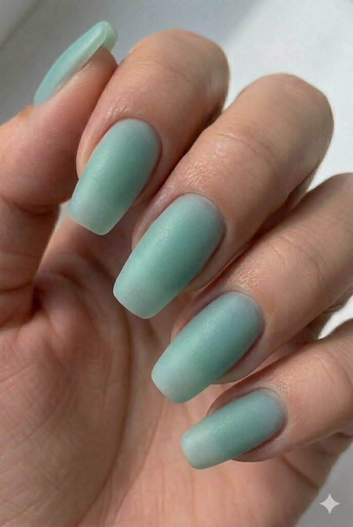 Beach glass sea green summer nail design with soft frosted green-blue shade like tumbled sea glass, coastal summer nail idea 2026