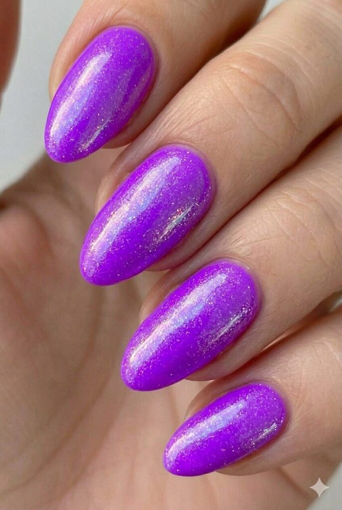 Electric purple neon summer nail design with bold bright purple-violet shade glowing under lights, edgy summer nail idea 2026