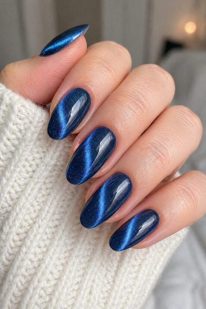 Blue cat eye velvet prom nails with magnetic glowing blue line and velvet finish