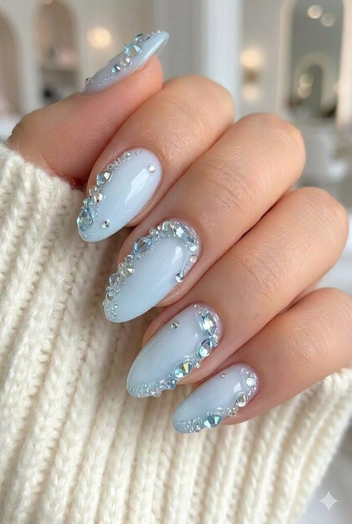 Blue crystal drip prom nails with glossy blue base and crystal drip details