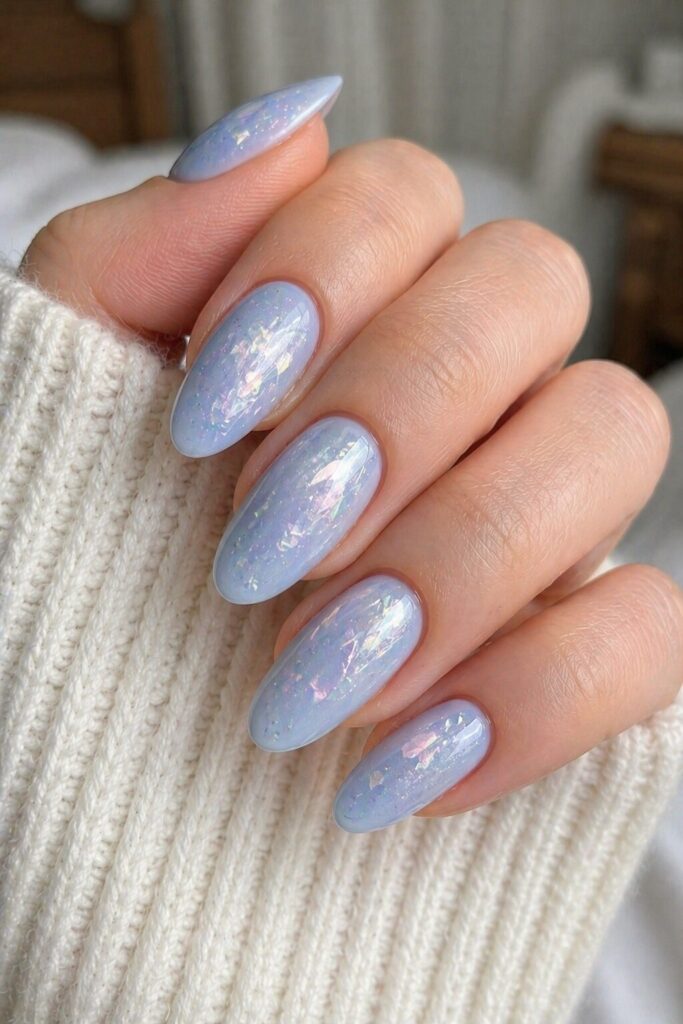 Blue opal veil prom nails with soft blue base and opal-like white silver shift