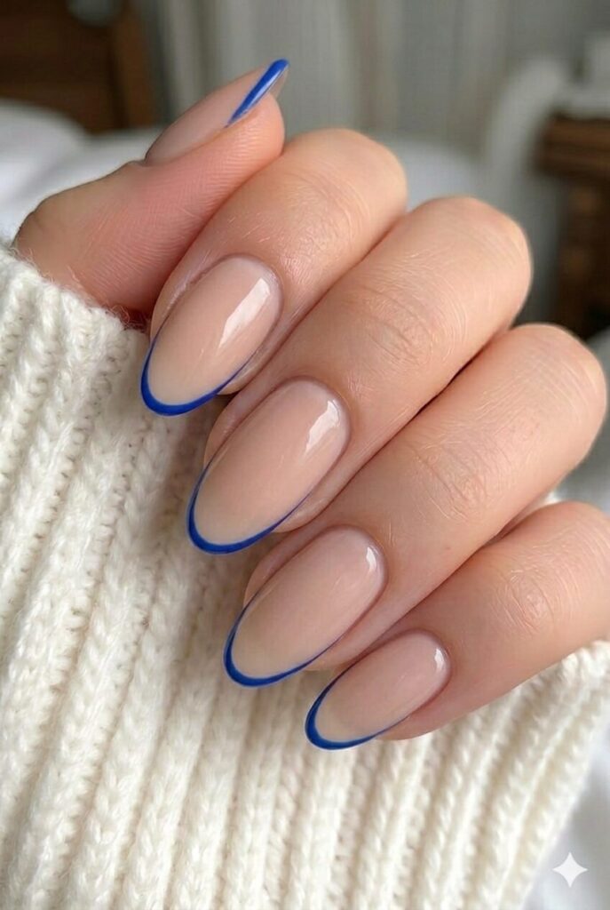Cobalt outline nude prom nails with nude base and thin cobalt blue border