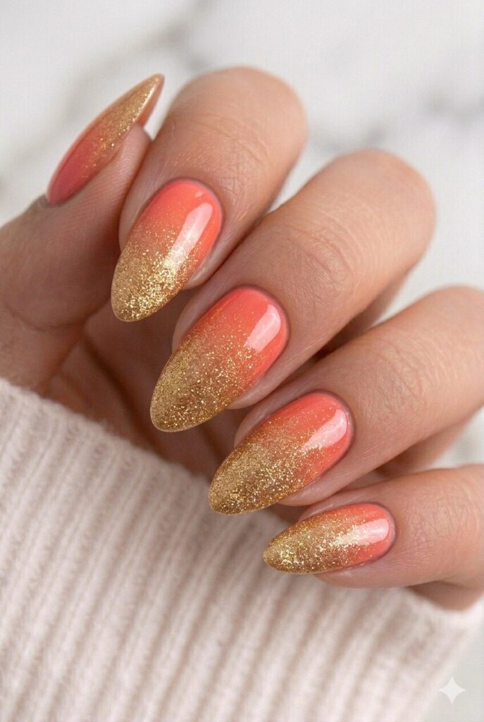 Coral and gold sunset graduation nails with a warm ombre shimmer for a glowing festive style