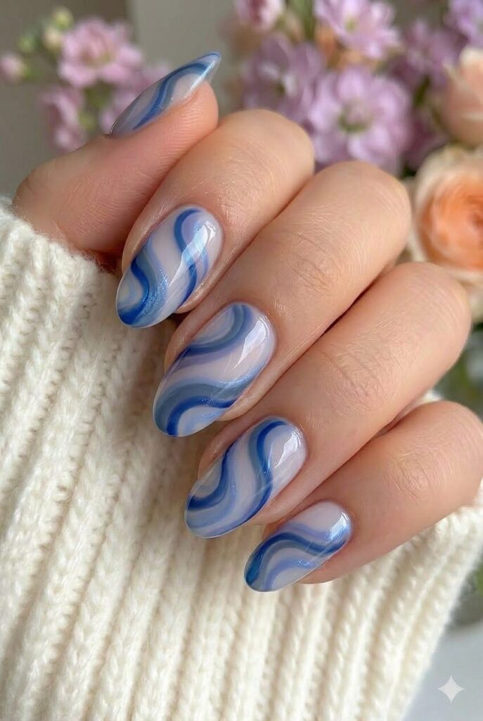 Evening sky swirl blue prom nails with mixed blue tones in flowing swirl art