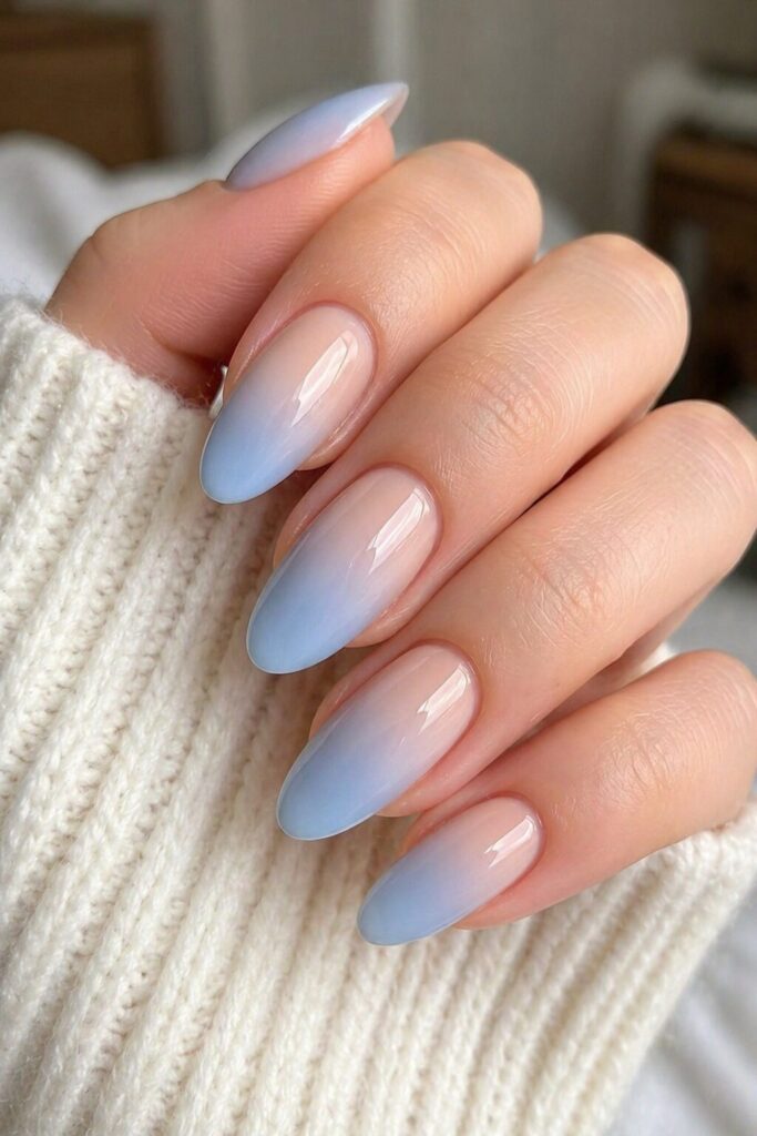 Glacier ombre blue prom nails fading from nude base into cool icy blue tips