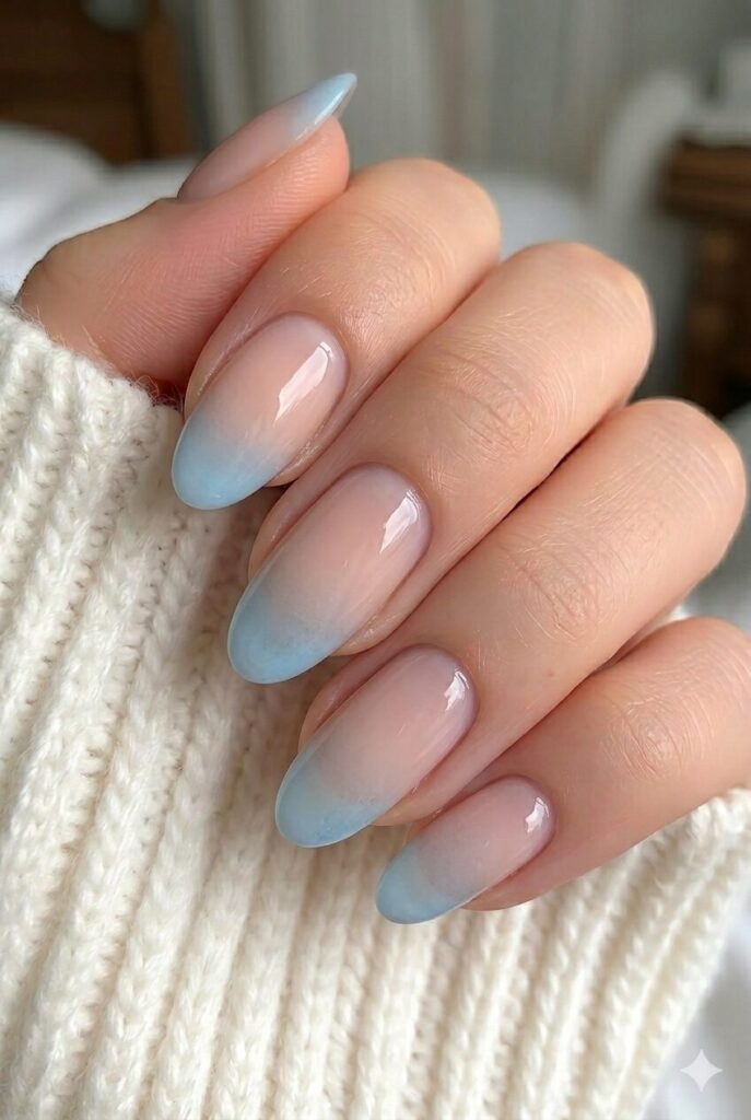Ice blue French mist prom nails with icy blue tips over a soft nude base