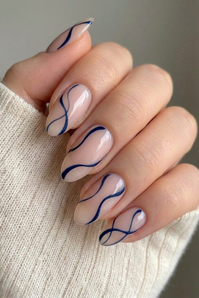Midnight ribbon line blue prom nails with nude base and thin dark blue flowing lines