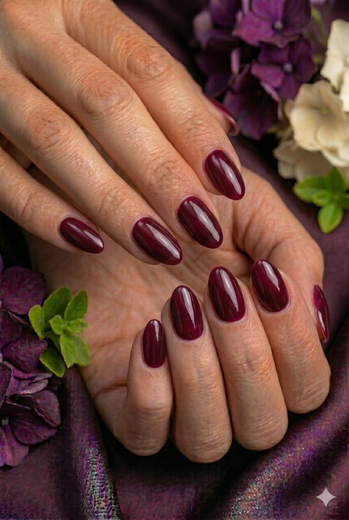 Mulberry shine prom nails with a deep berry glossy finish for a rich and classy style