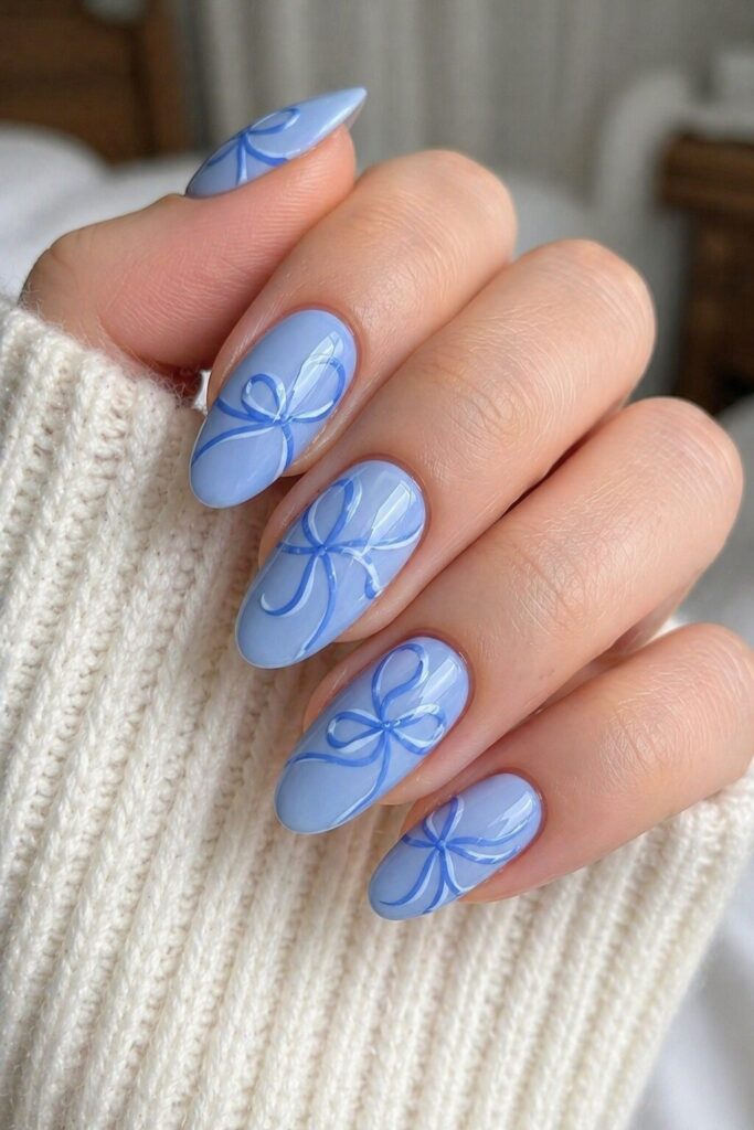 Periwinkle ribbon swirl blue prom nails with soft periwinkle base and flowing line art