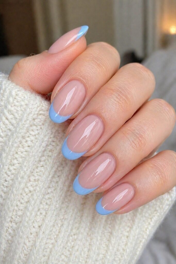 Porcelain blue French prom nails with nude base and crisp porcelain blue tips