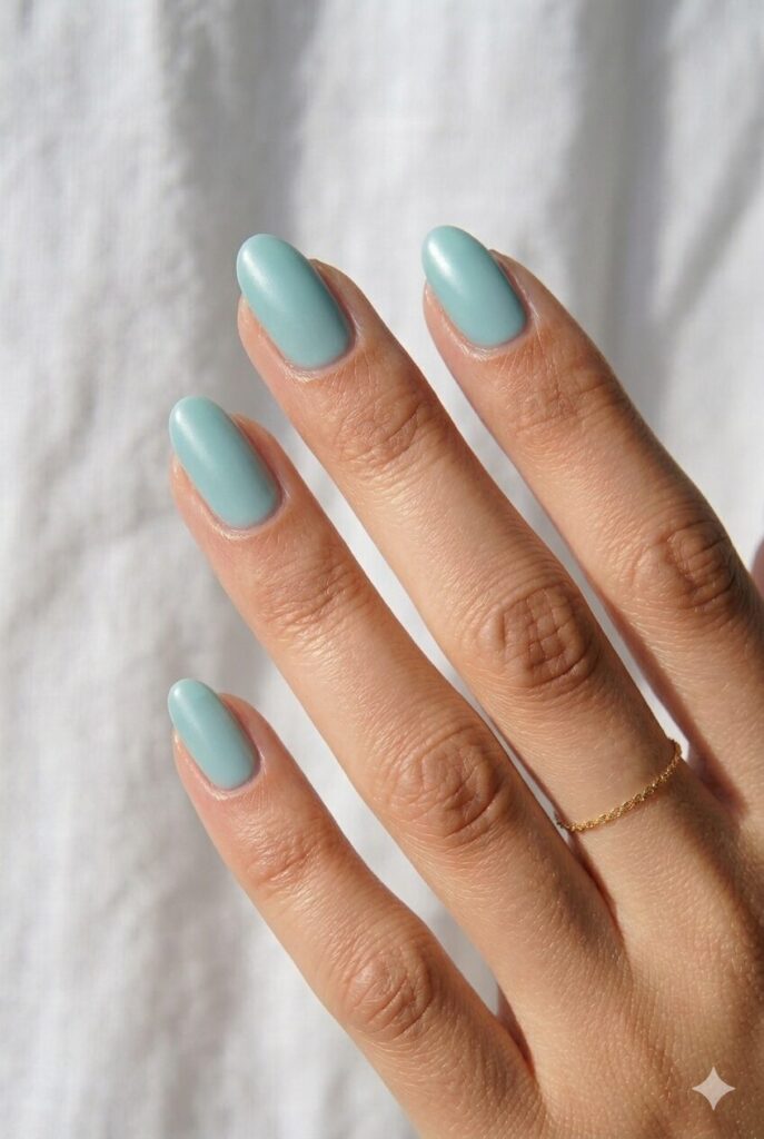Simple May nail ideas in a soft seafoam blue-green shade with a smooth satin finish