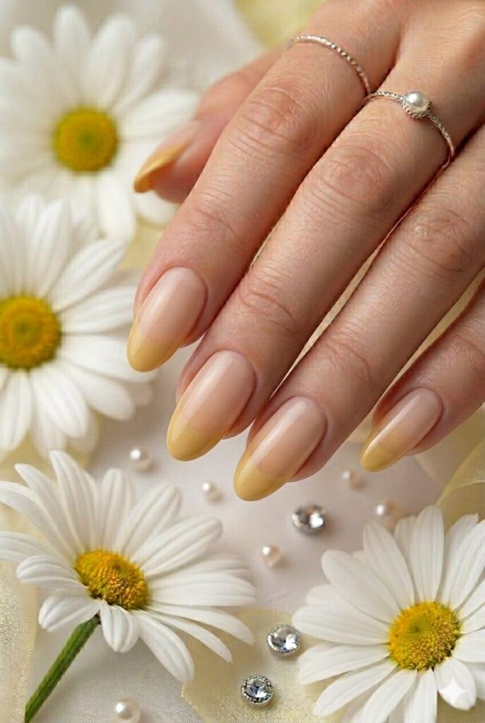 Soft ochre French fade yellow prom nails with muted golden tips over a nude base