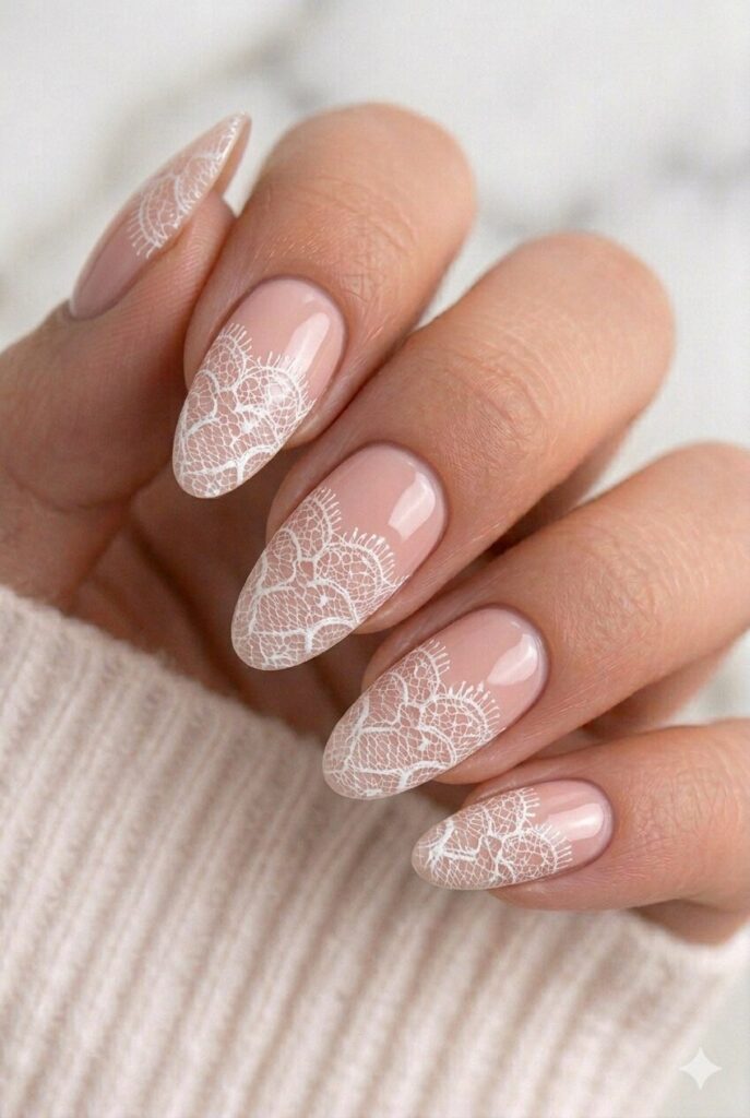 White lace pattern graduation nails on a nude base for a delicate and elegant manicure
