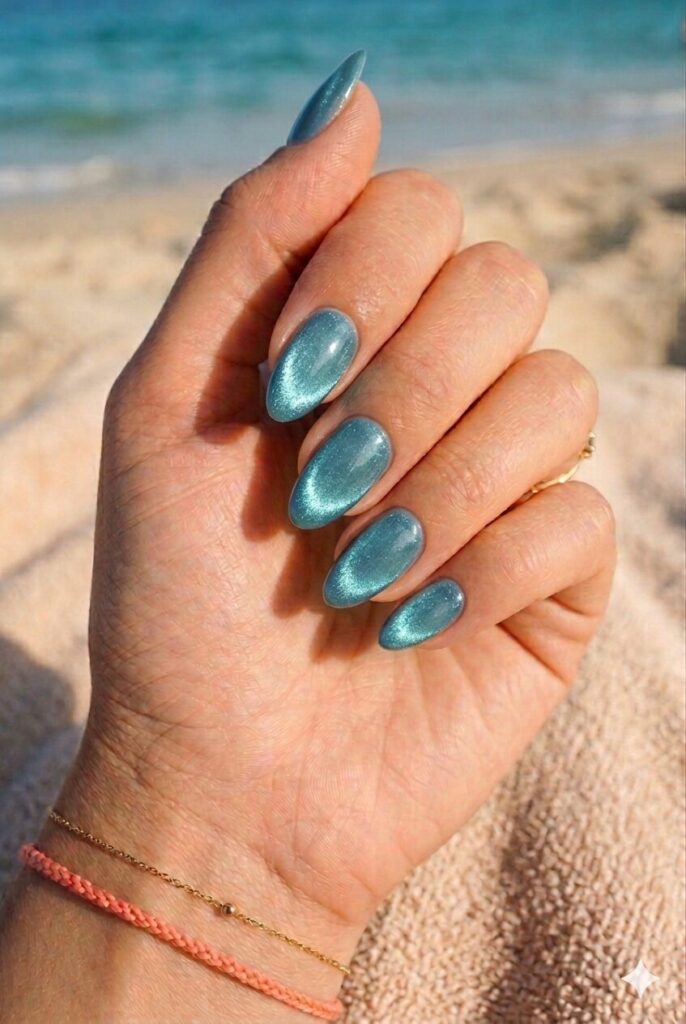 Almond nails with blue green cat eye glassy shimmer finish