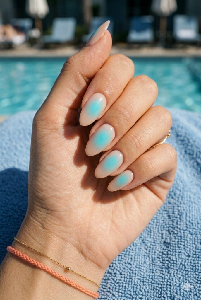 Long almond nails with sheer base and bright blue aura glow