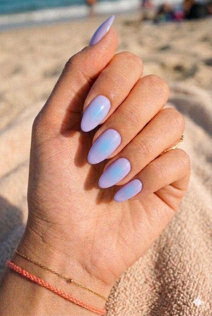 Almond nails with soft lavender and faint blue aura glow center