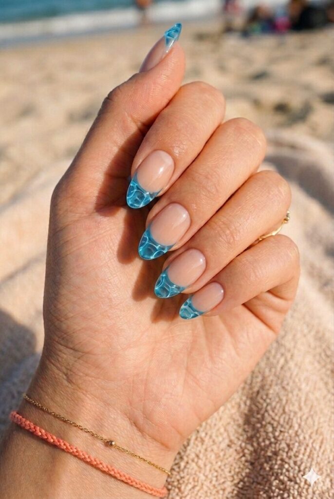 Almond nails with nude base and clear blue ripple French tips