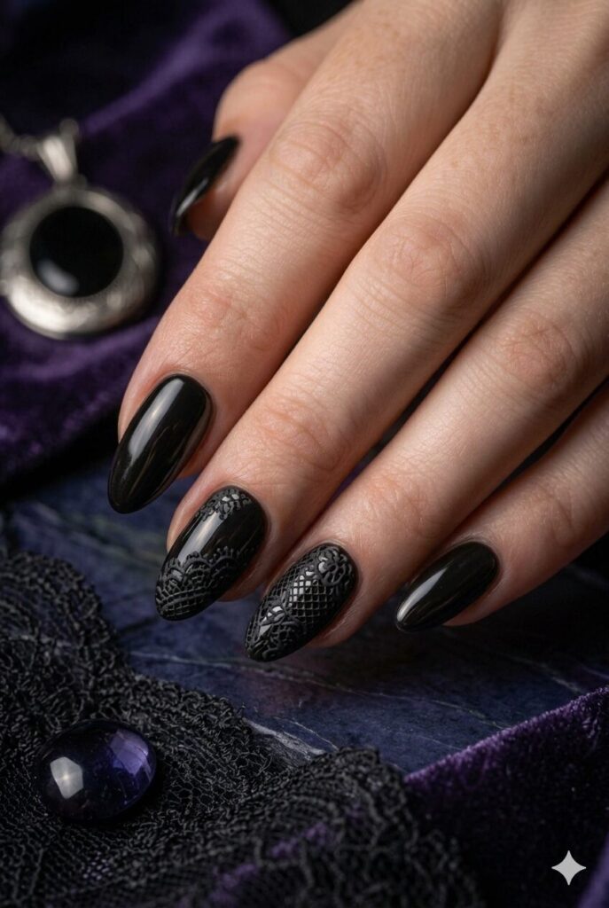 Almond nails with black polish and delicate black lace pattern art