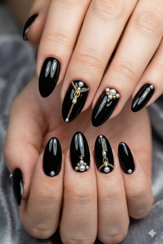 Almond nails with glossy black base white pearls and gold details