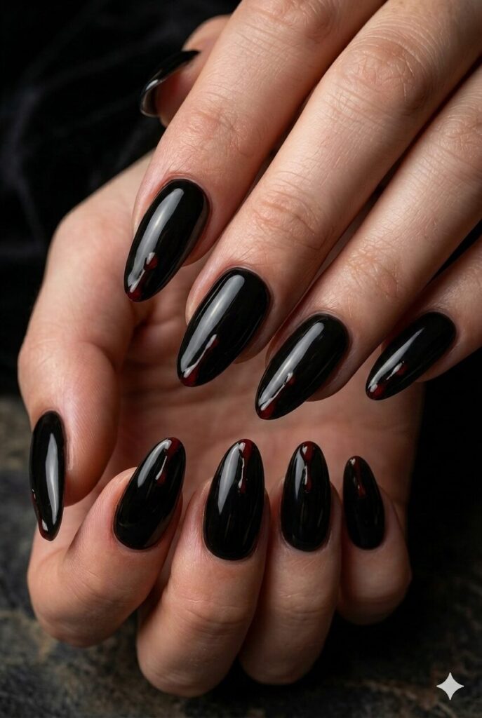 Short almond nails with red blood drip accents from the tips