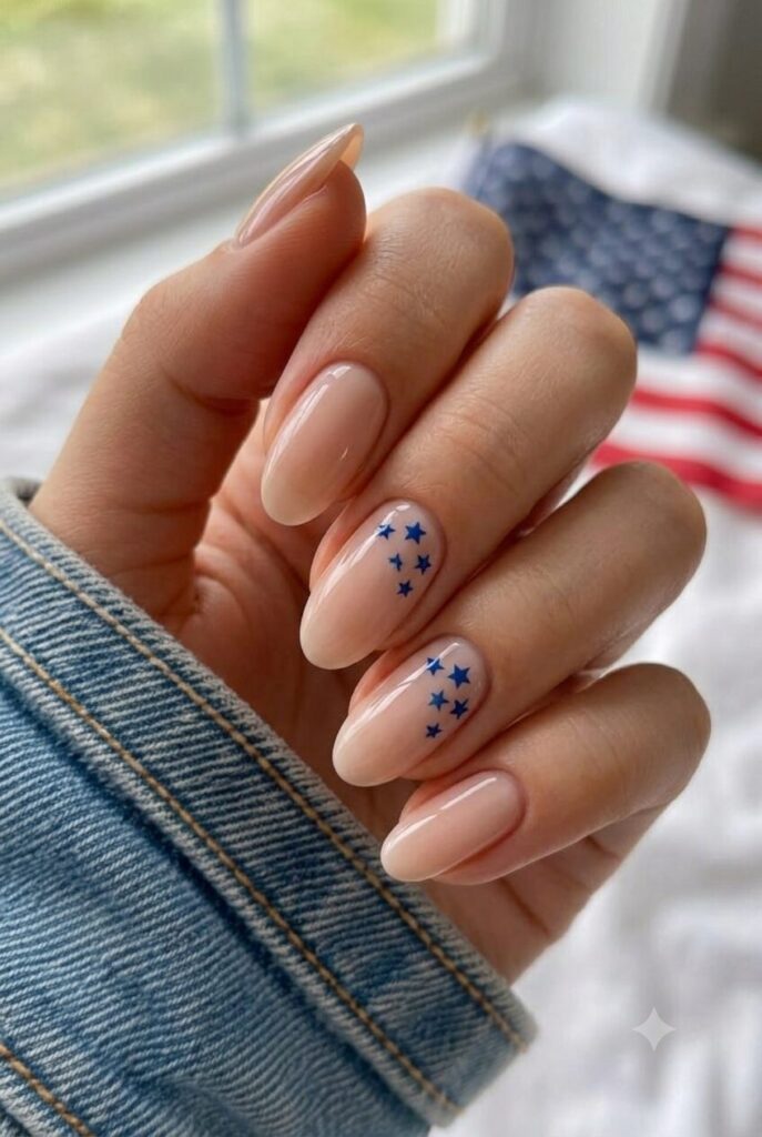 Short almond nails with white base and tiny blue star cluster accents