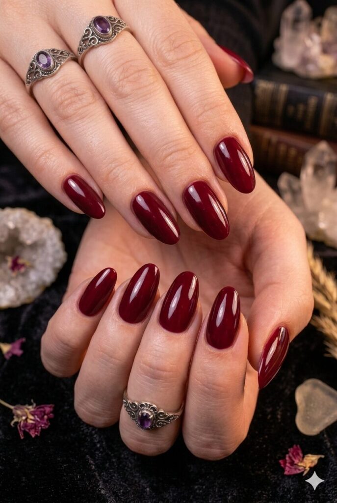 Short almond nails with glossy dark cherry mystical polish