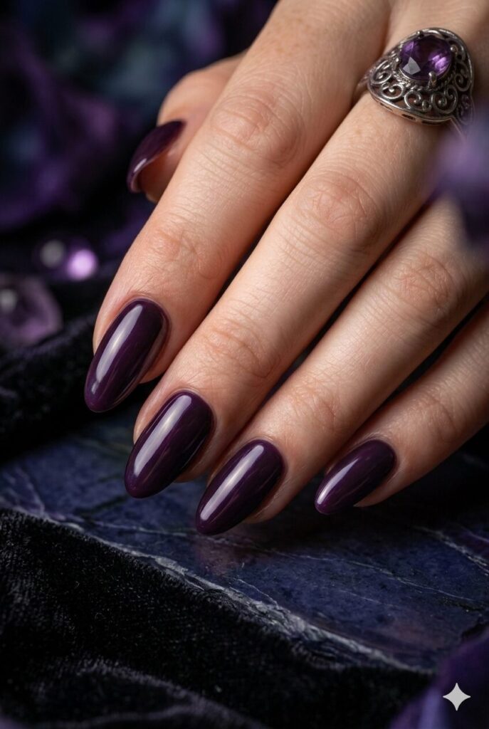 Short almond nails with glossy dark plum glazed finish