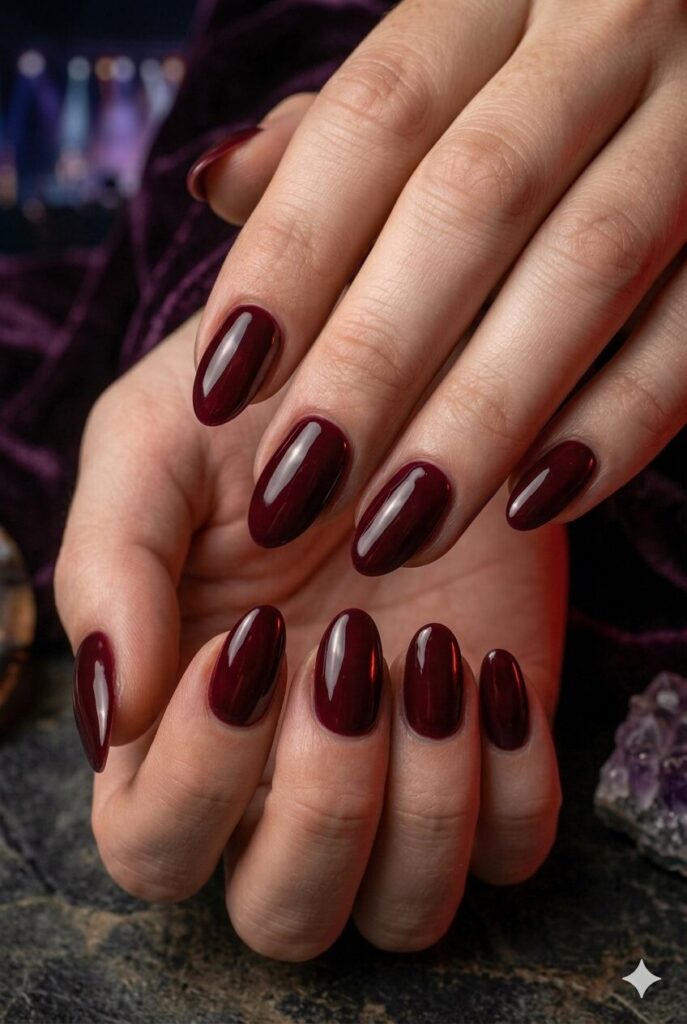 Short almond nails with glossy deep wine moody polish