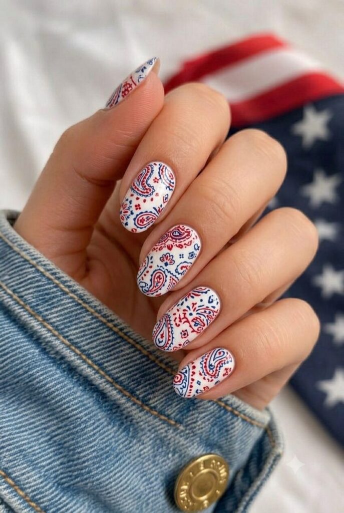 Short oval nails with white base and tiny red and blue bandana print details