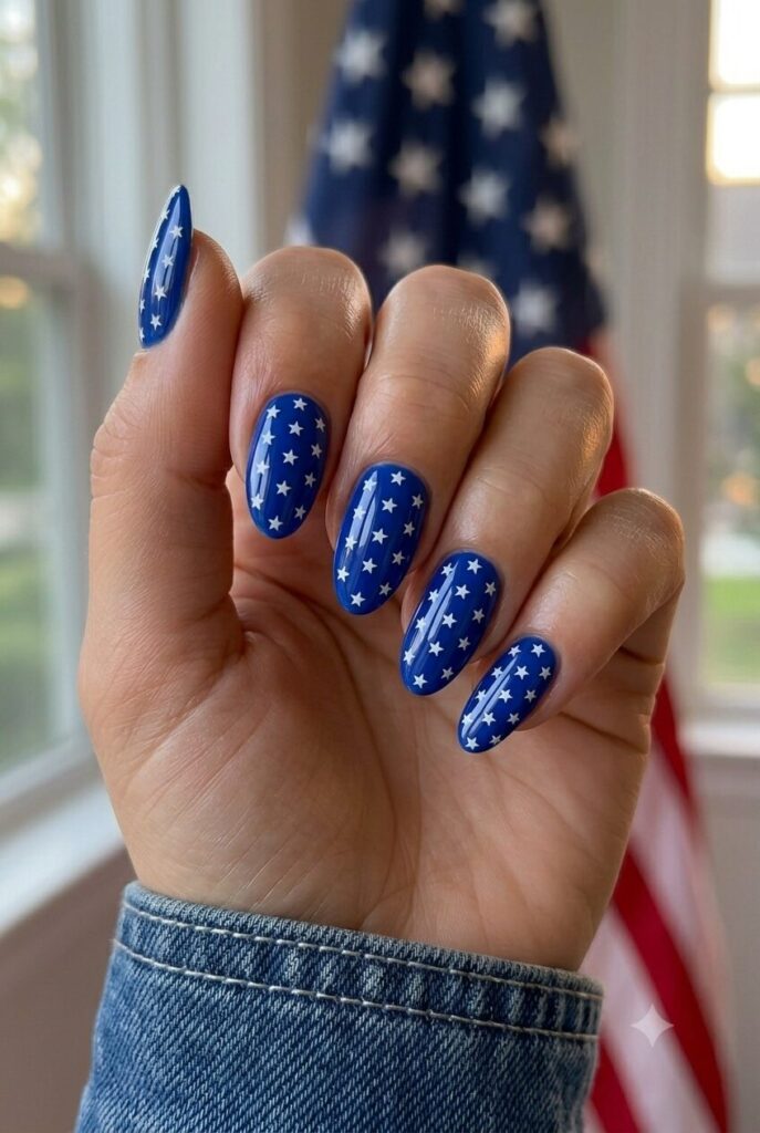 Short almond nails with bright blue polish and all over tiny white star accents