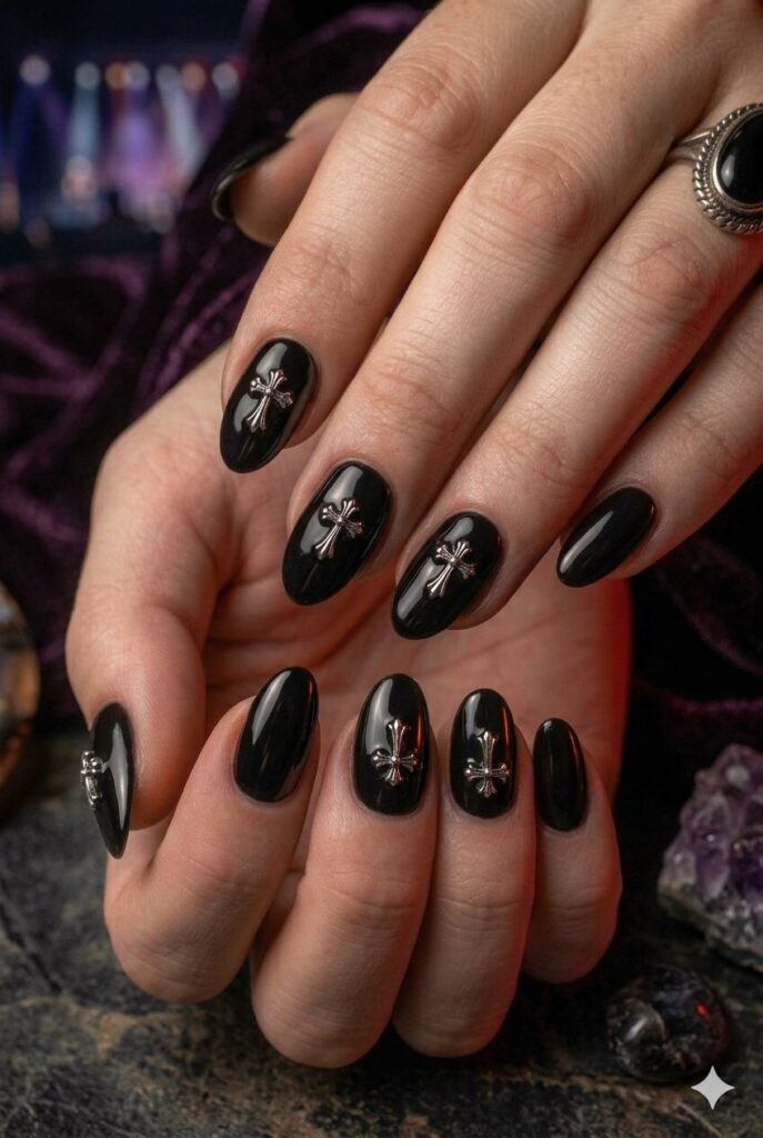 Short almond nails with black base and tiny silver cross accents