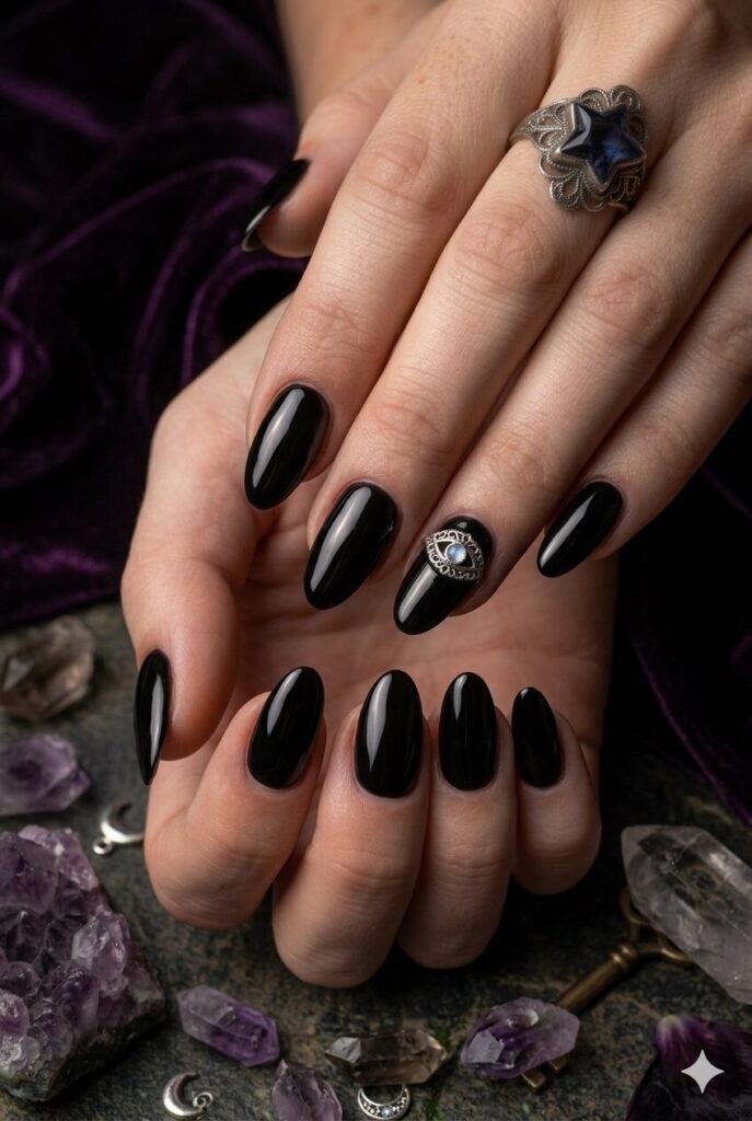 Short almond nails with black base and tiny mystical silver eye accent