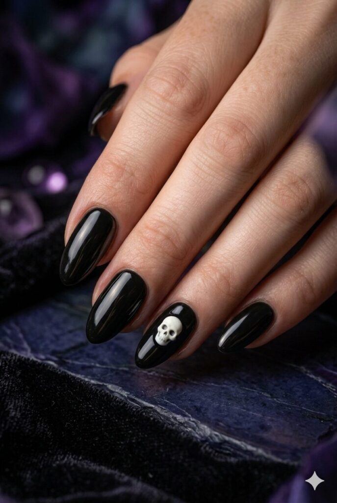 Short almond nails with black base and tiny white skull accent