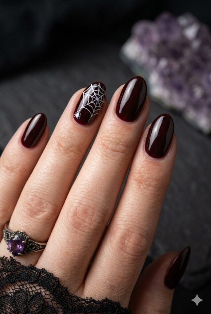 Short almond nails with black base and white spider web accents