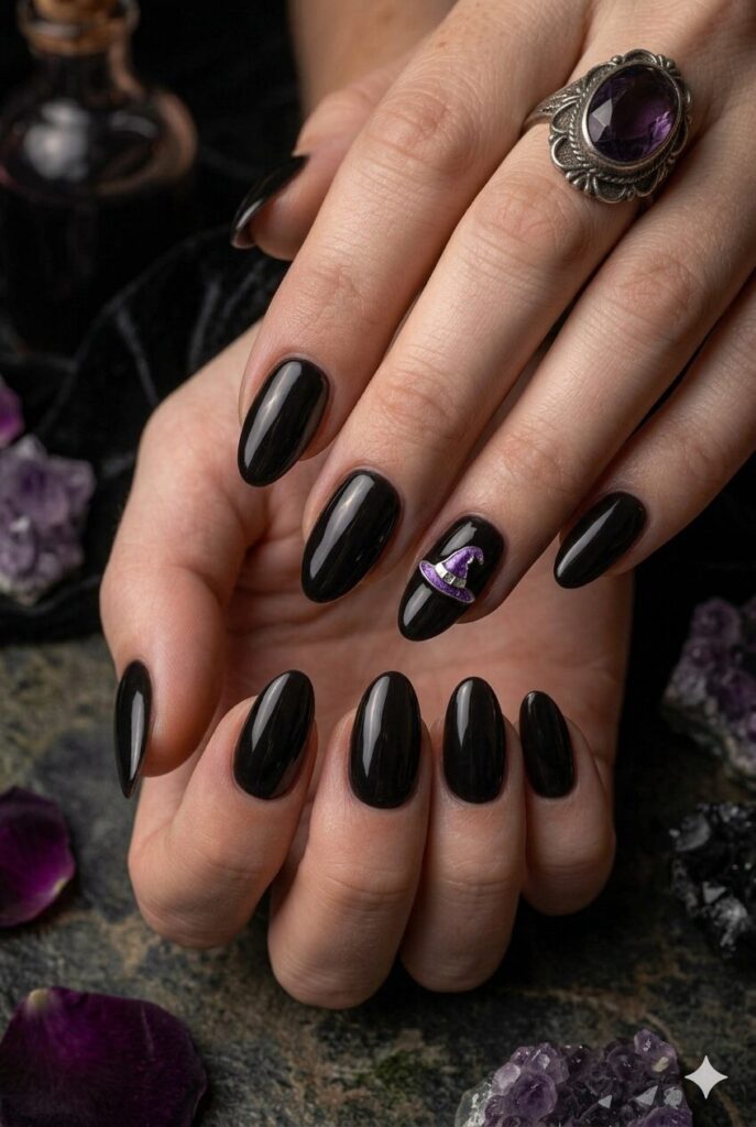 Short almond nails with black base and tiny purple witch hat accent