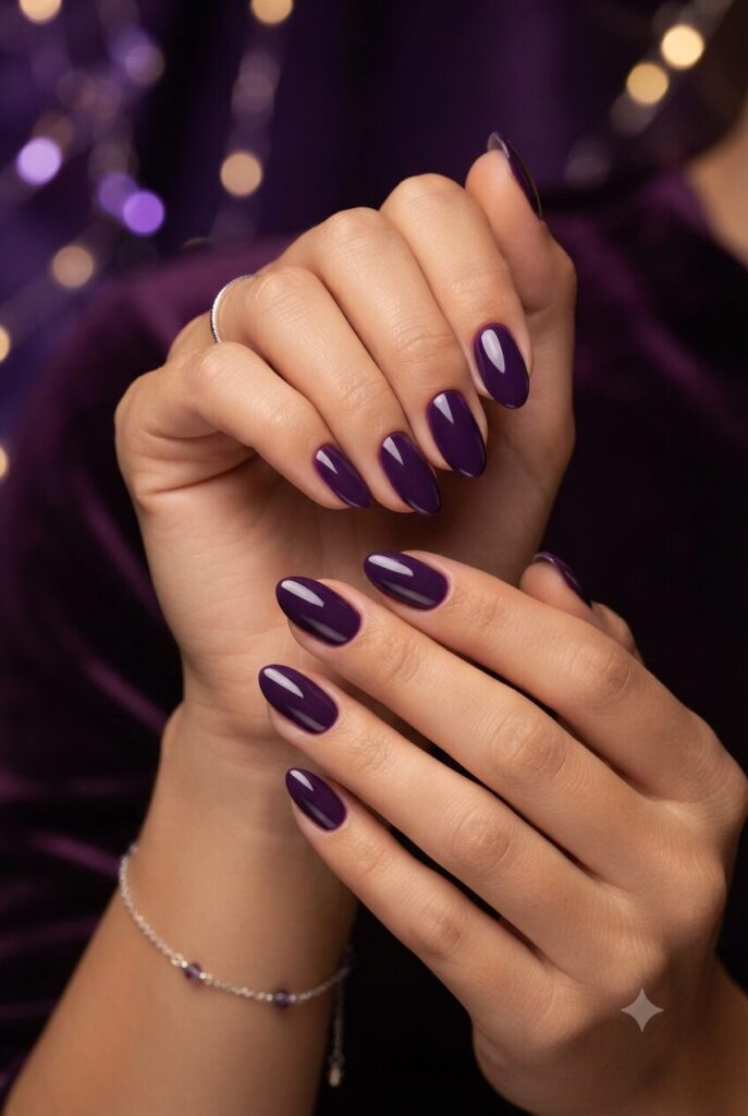 Short almond nails with bold glossy deep purple polish