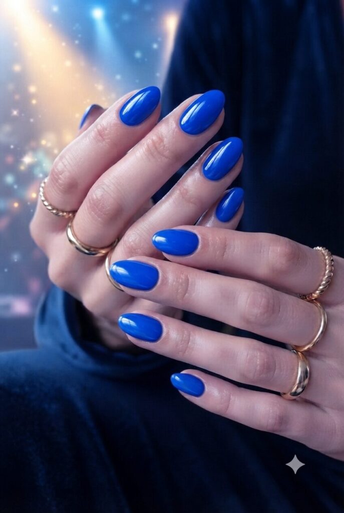 Short almond nails with bold glossy electric blue polish