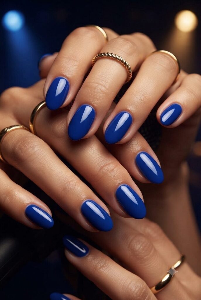 Short almond nails with bold glossy royal blue polish