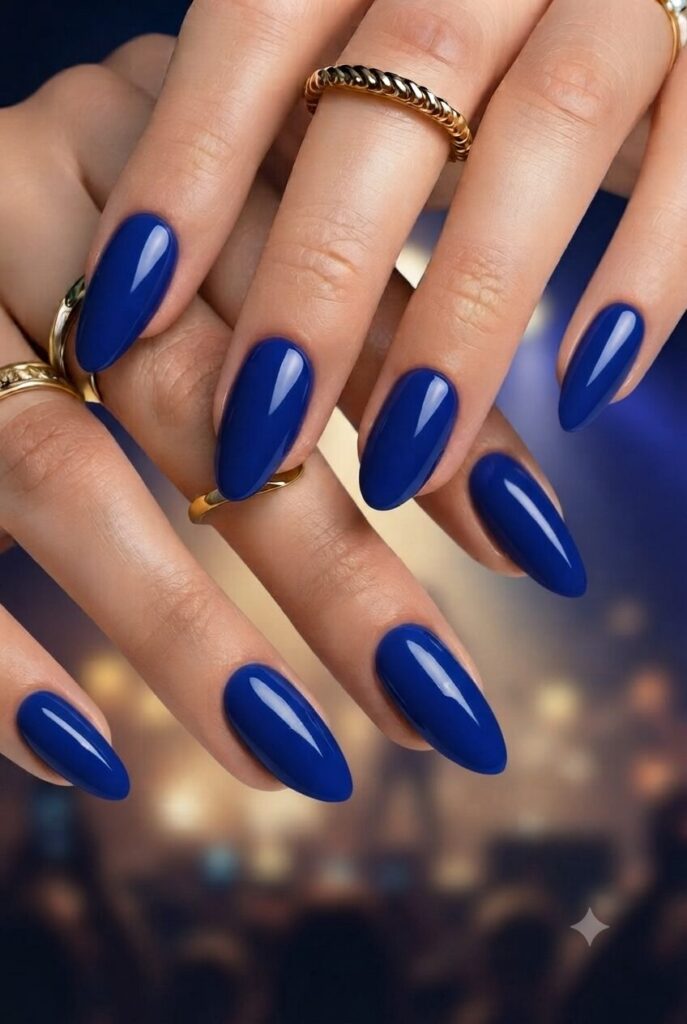 Short almond nails with bold glossy sapphire blue polish