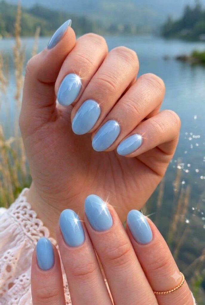 Short almond nails with glossy soft crystal blue water polish