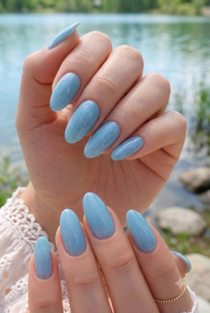 Short almond nails with glossy soft lake blue water-inspired polish