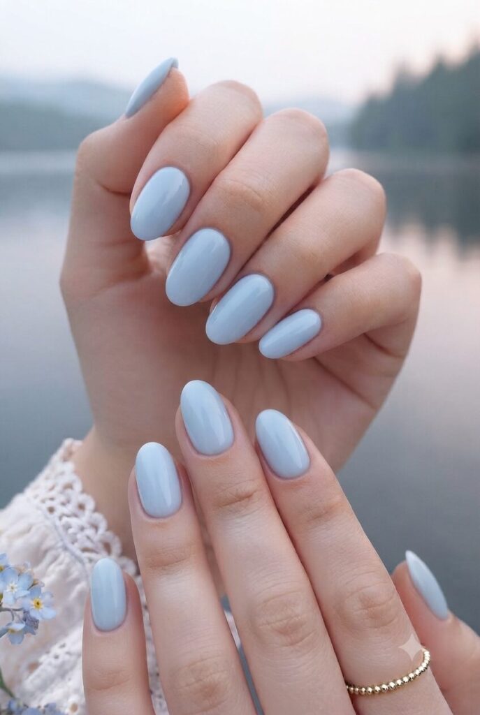 Short oval nails with glossy soft mist blue water polish