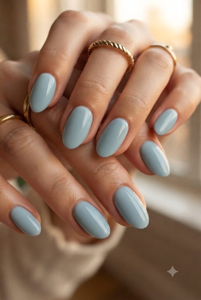 Short almond nails with glossy soft ocean blue polish