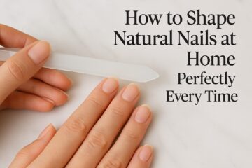 How to shape natural nails at home featured image showing a woman filing her nails with a glass file