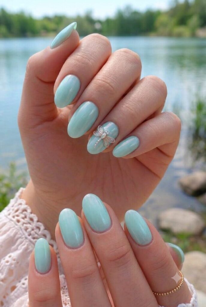 Short almond nails with soft aqua and smooth pearl sheen finish