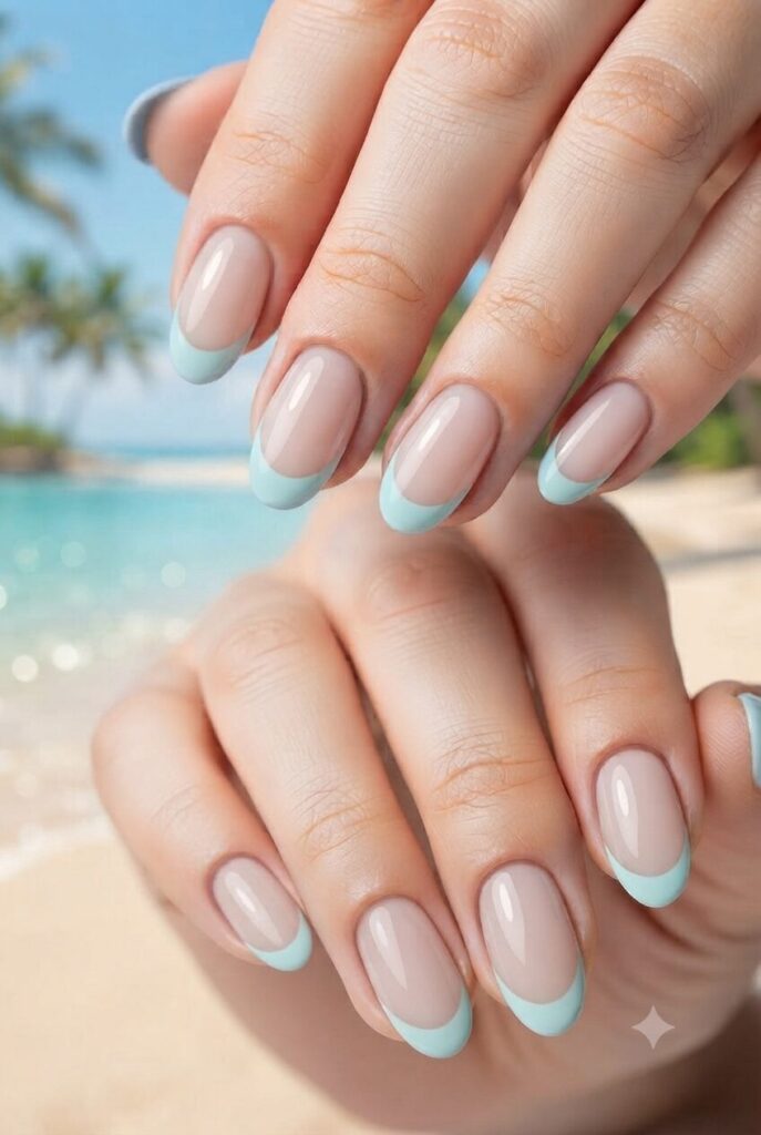 Short almond nails with nude base and soft aqua French tips